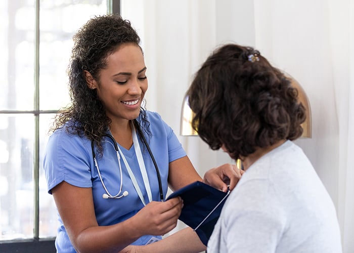 International nurse taking a patient's blood pressure
