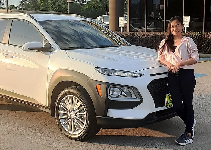 lady standing next to a white SUV lady standing next to a white SUV