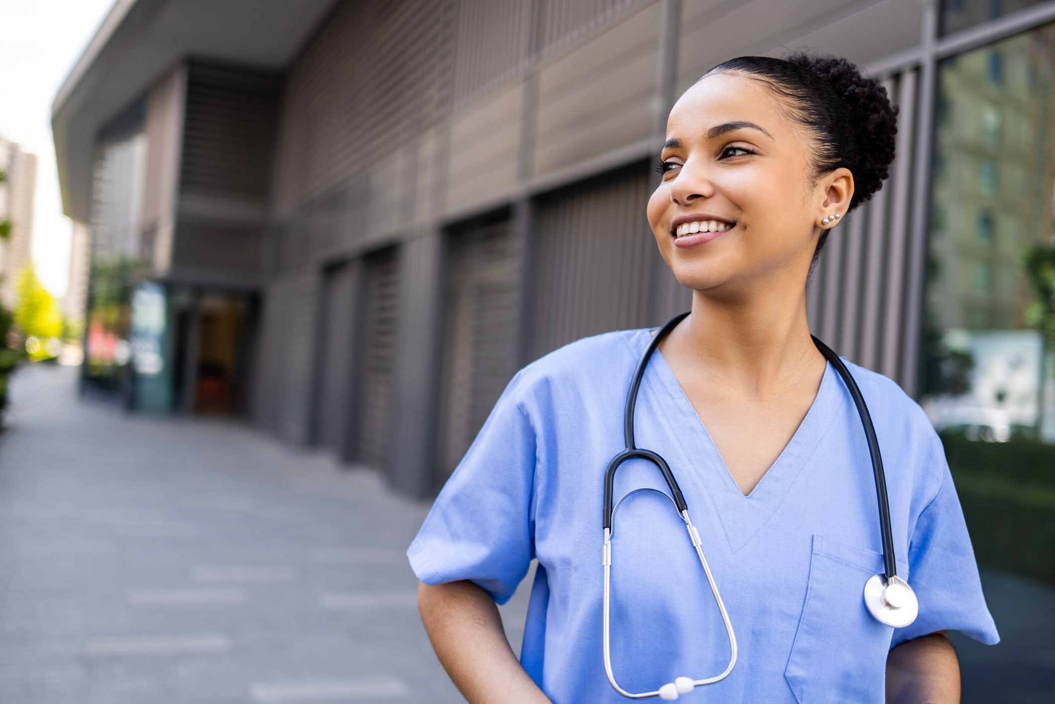 Female nurse in uniform outdoors with a stethoscope around her neck Female nurse in uniform outdoors with a stethoscope around her neck
