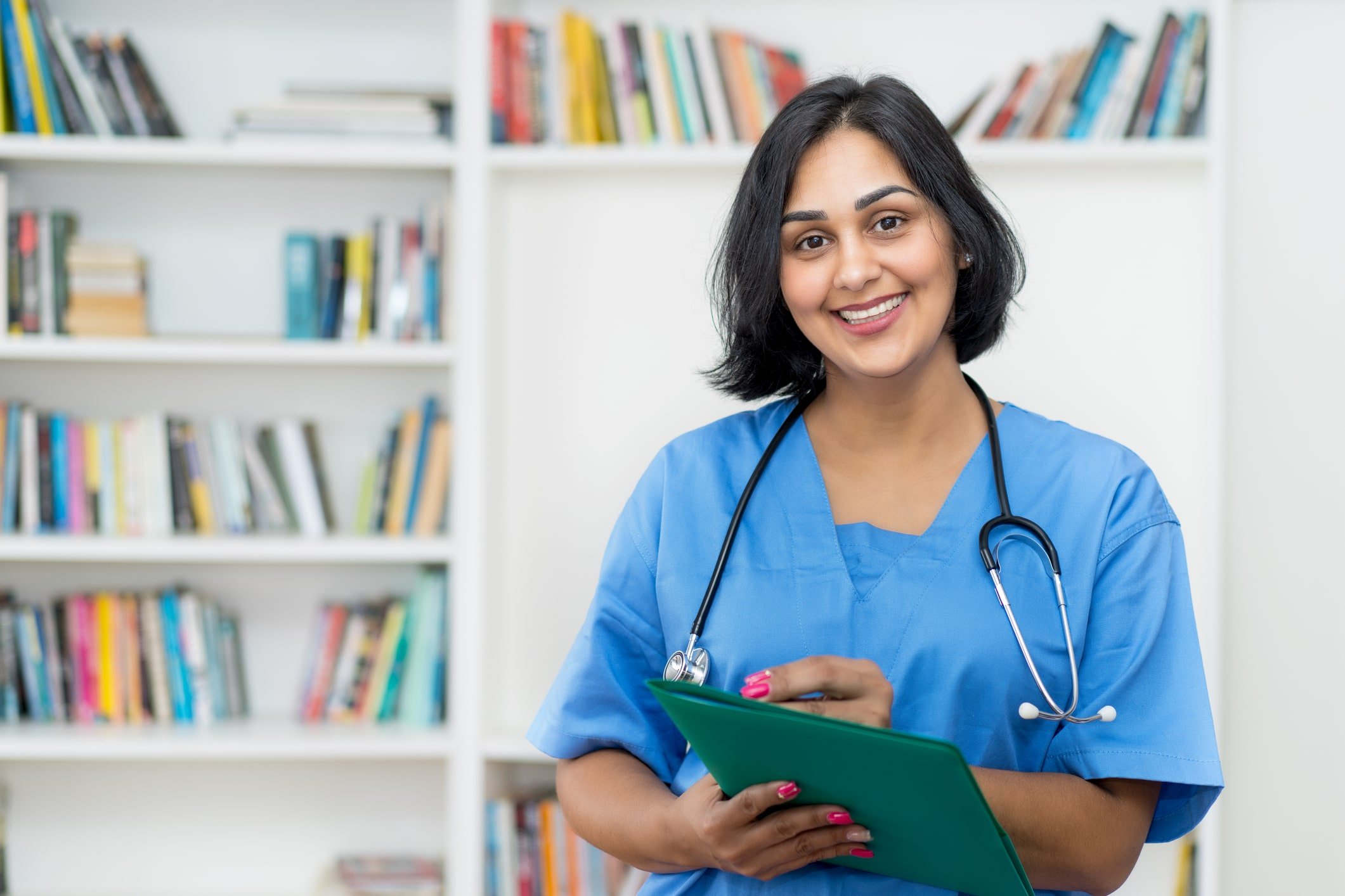 Nurse smiling holding patient file Nurse smiling holding patient file
