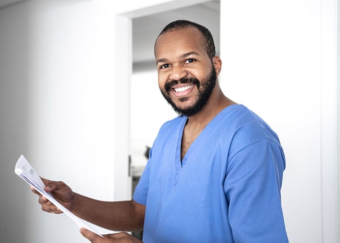 Smiling male nurse in blue scrubs Smiling male nurse in blue scrubs
